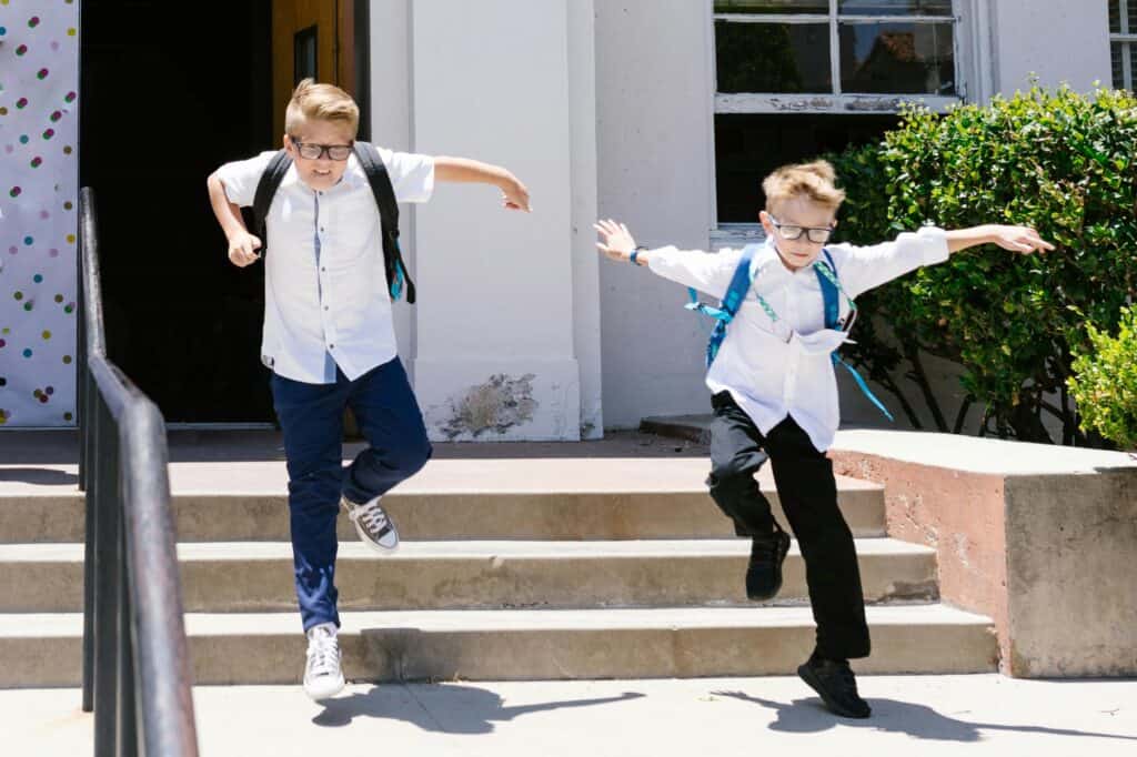 Two young male students ran down the stairs